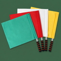 Four referee hand signal flags on green background